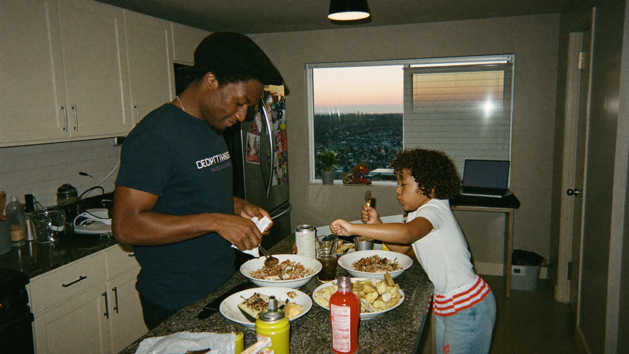 Father and daughter making dinner together at home