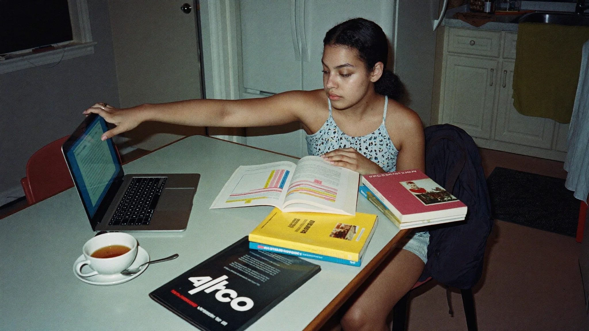 Renter returning to her studies at her kitchen table